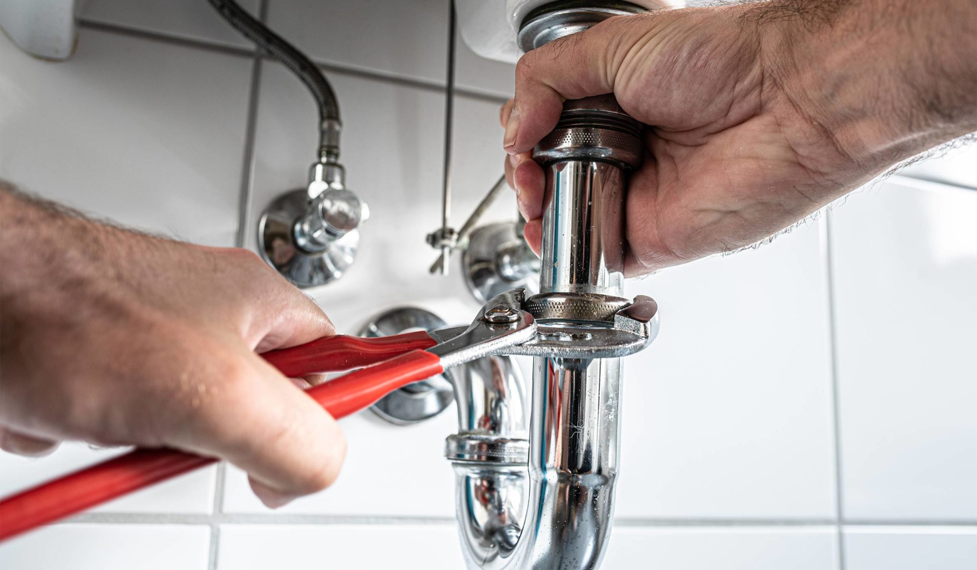plumber hands close up with toll repairing bathroom sink pipe glenmora la