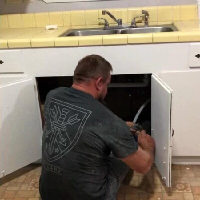 plumber doing a drain cleaning in a kitchen sink glenmora la